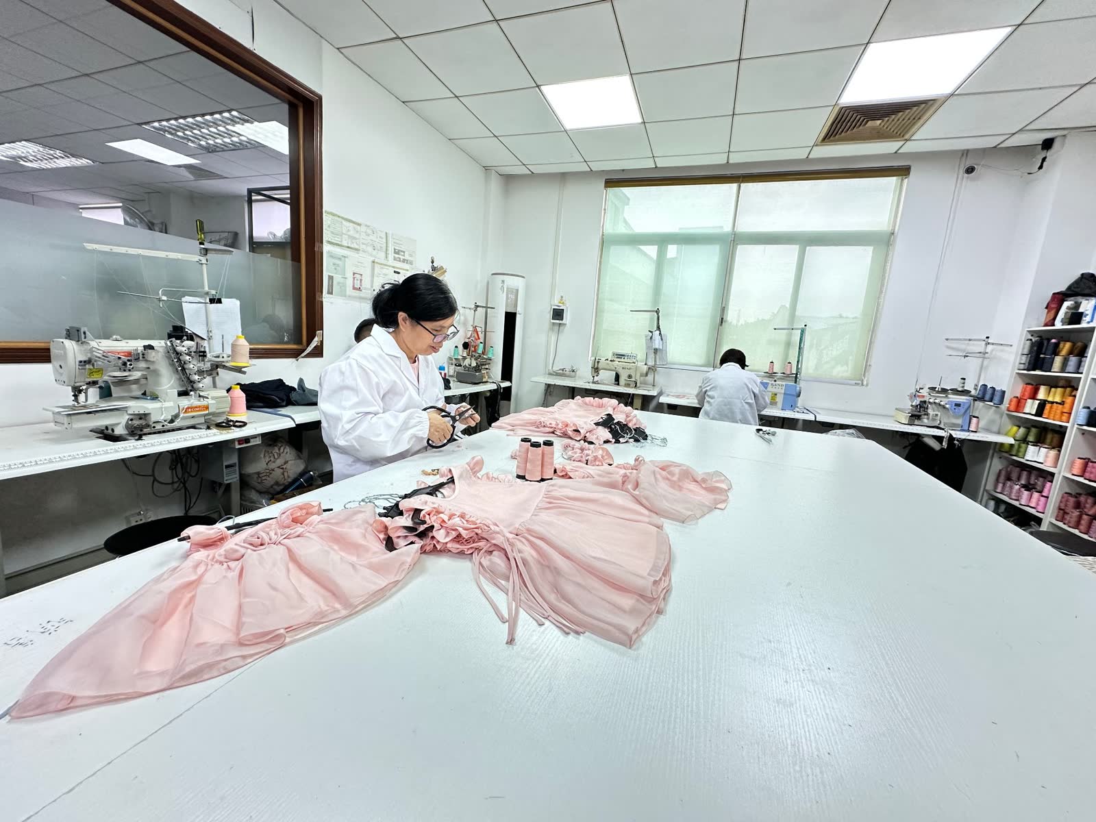 Close-up stitching pale pink silk blend on a JAND industrial machine